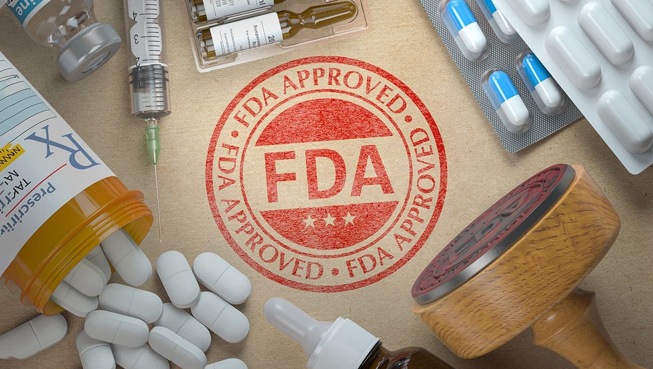 Maksym Yemelyanov/stock.adobe.com – photo of FDA approval stamp surrounded by various pharmaceutical dosage forms