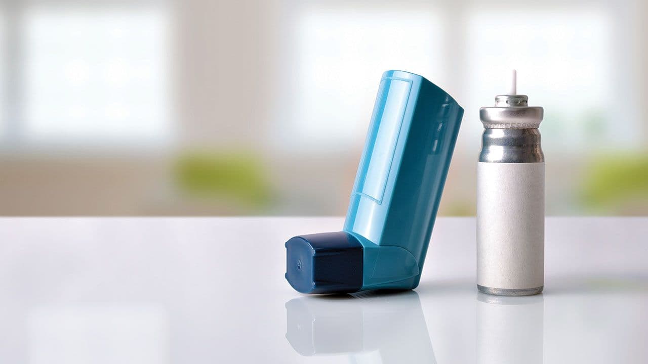 Cartridge and blue medicine inhaler in a room front view | Image Credit: ©Davizro Photography - stock.adobe.com