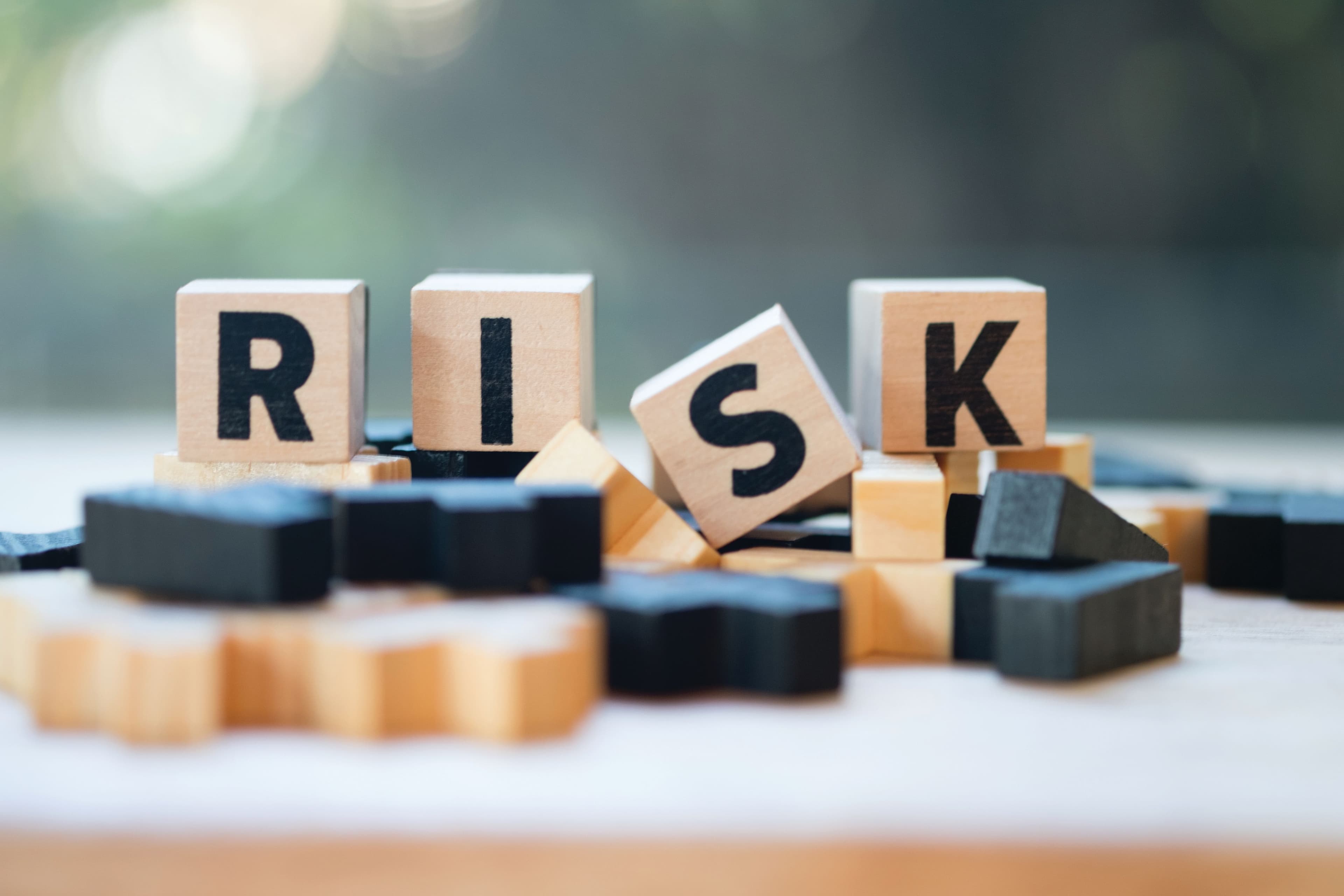 Cube wooden block with alphabet building the word RISK. Risk assessment | Image Credit: ©Dontree - stock.adobe.com