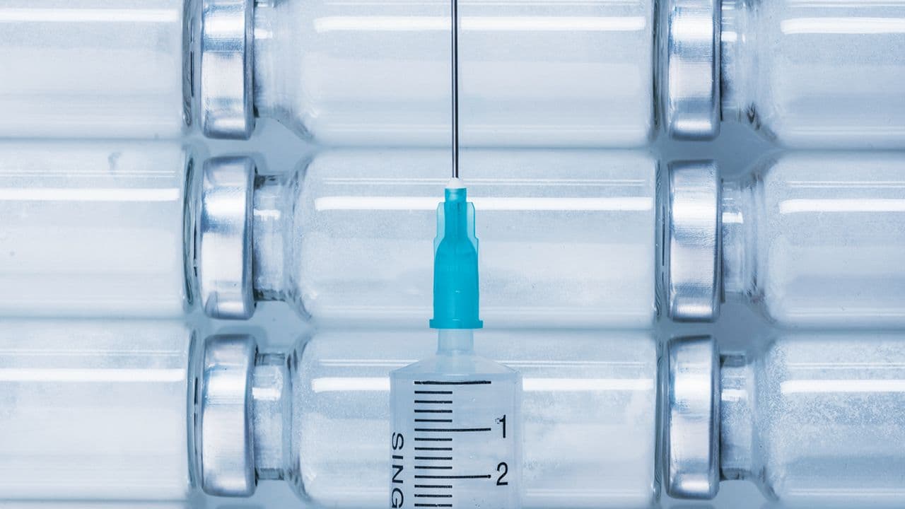 Medicine, Injection, vaccine and disposable syringe, drug concept. Sterile vial medical syringe needle. Glass medical ampoule vial for injection. | Image Credit: © ivandanru - Stock.Adobe.com