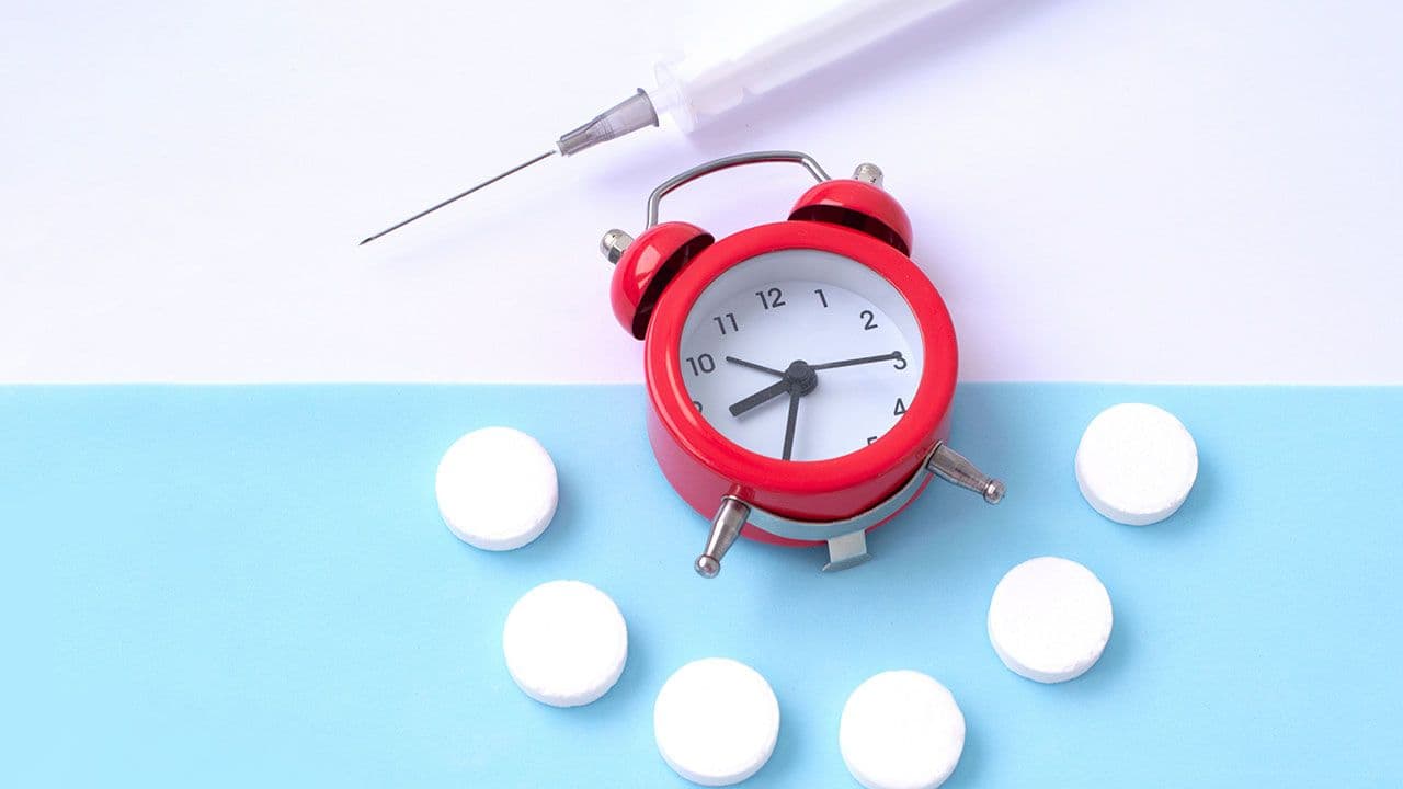 clock, pills, and syringe; drug delivery