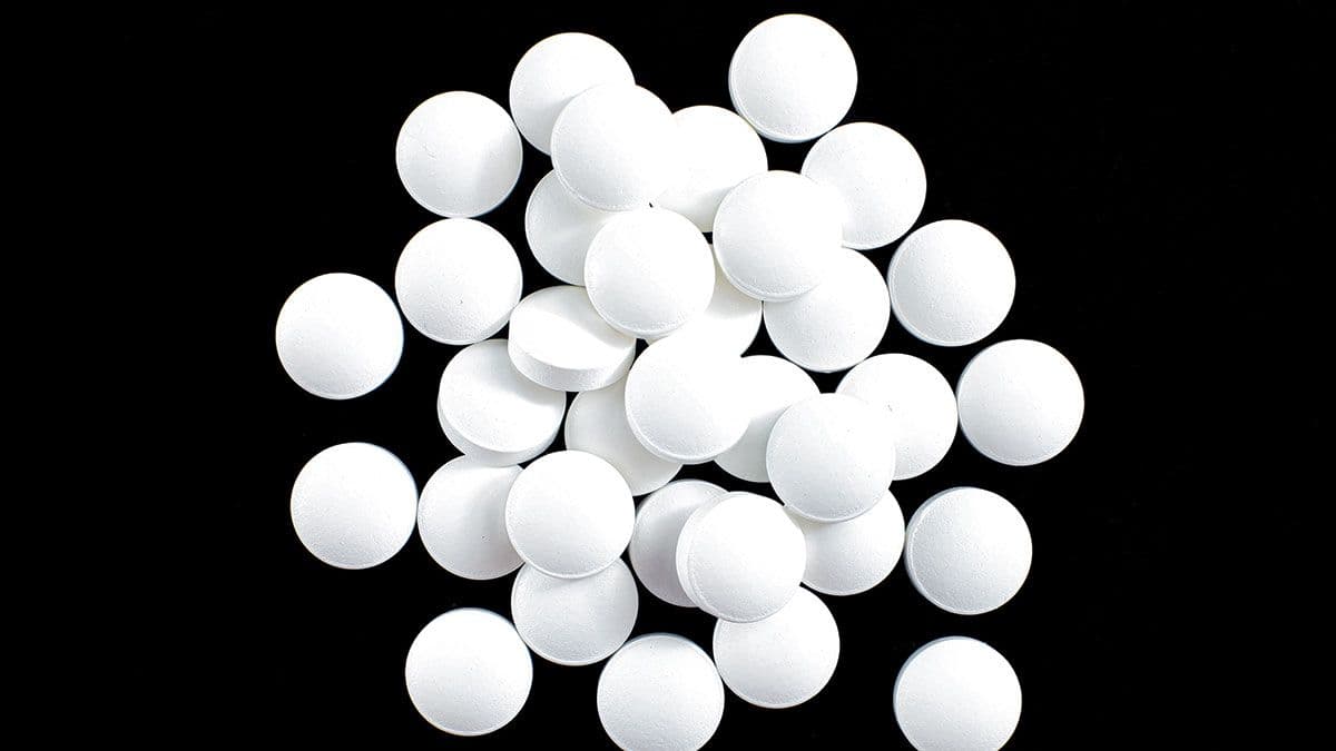 White round small pills on a black background, heap, top view, macro| Image Credit: ©Tetiana - stock.adobe.com